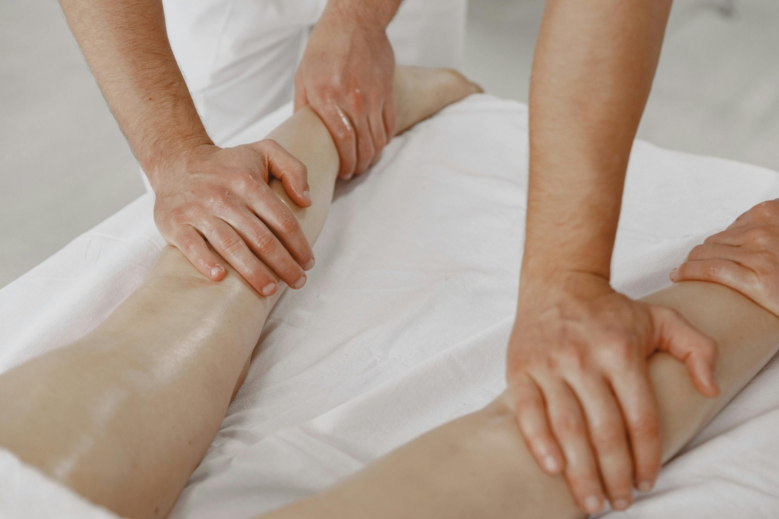 A close-up view of a leg massage in a relaxing spa environment.
