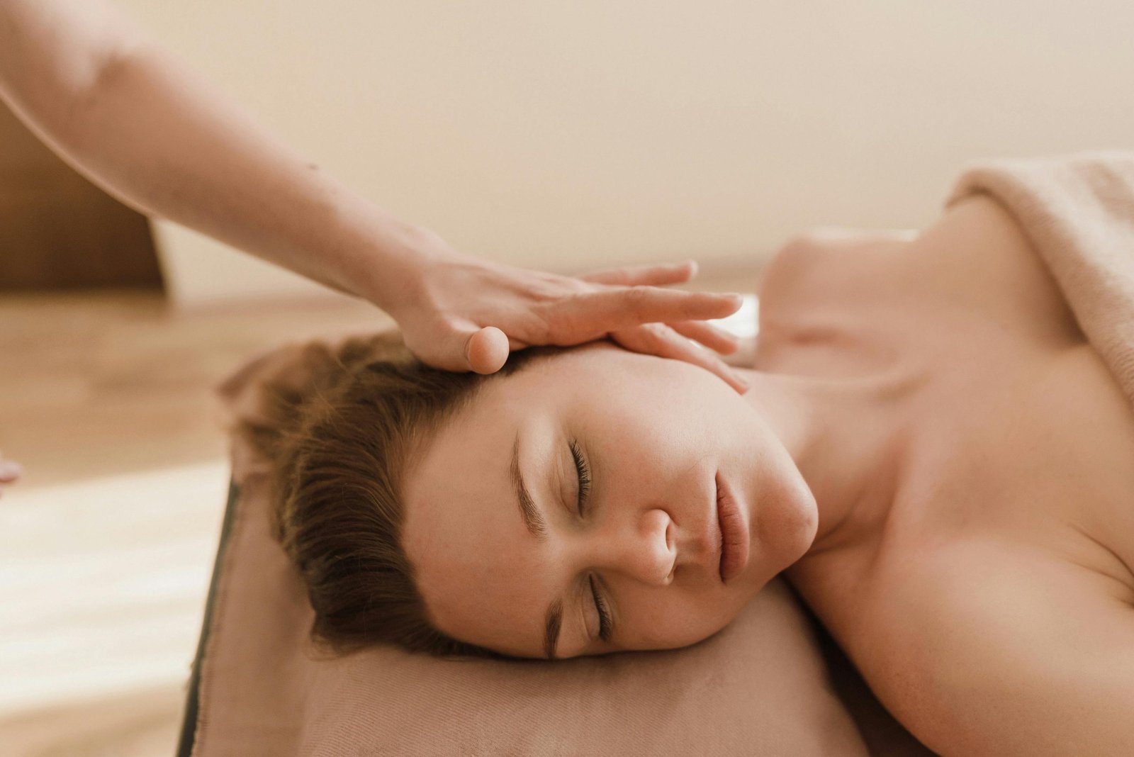 A woman receives a soothing head massage, promoting relaxation and stress relief.